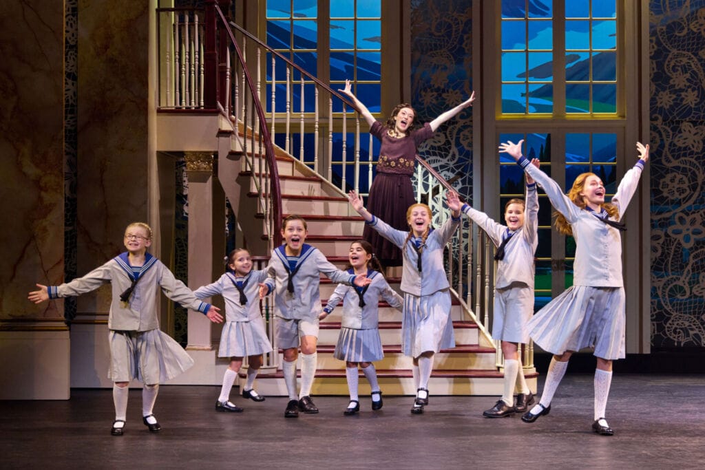 Women and children performing on stage