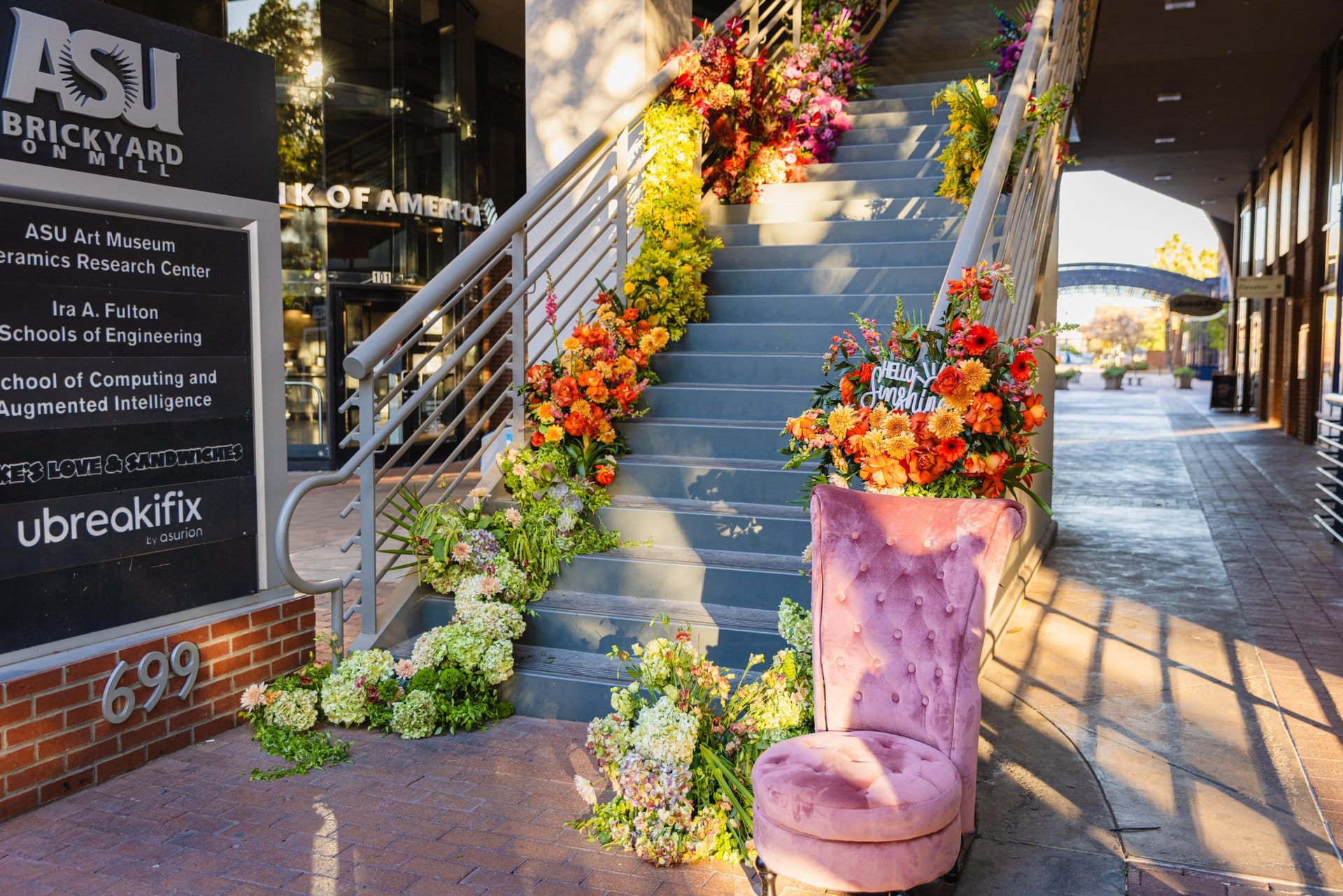 Staircase at ASU Brickyard decorated with bright floral arrangements.