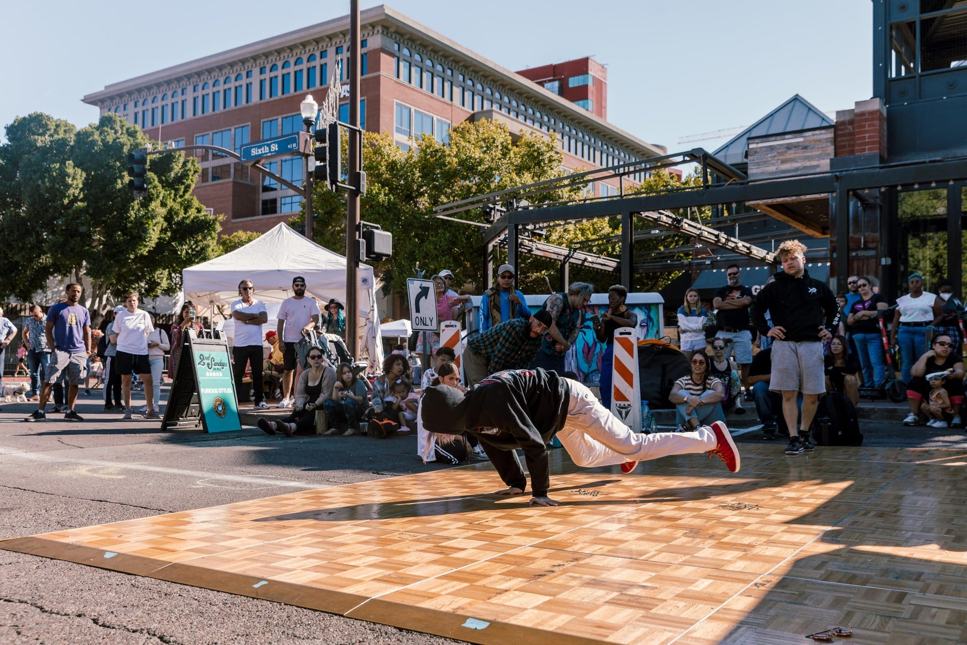Street performer breakdancing at 2nd Sundays on Mill event in Downtown Tempe