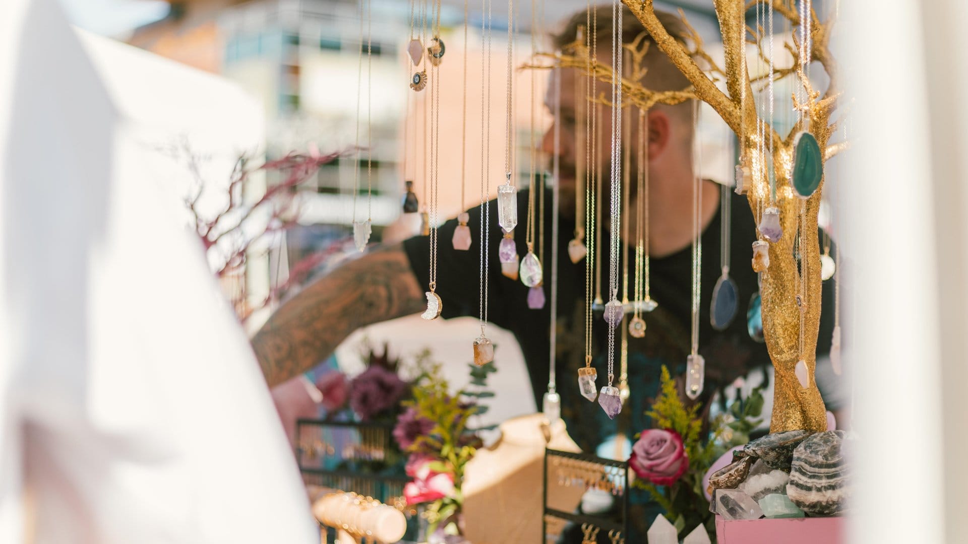 Handcrafted crystal jewelry on display at a local artisan booth at 2nd Sundays in Downtown Tempe