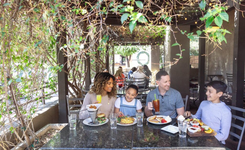 A family of four dining at Caffe Boa's patio