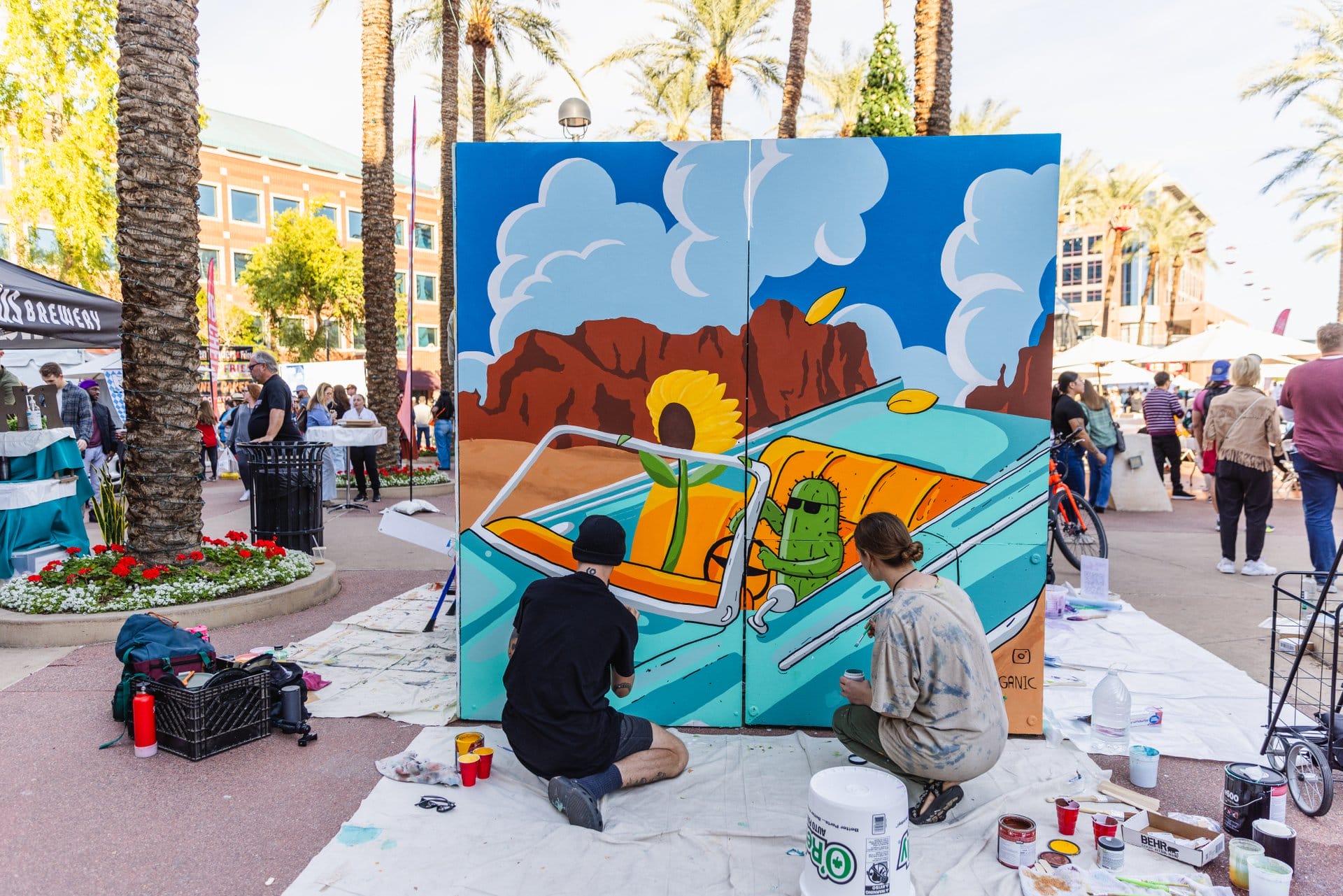 Muralists painting a live mural at Tempe Festival of the Arts in Downtown Tempe