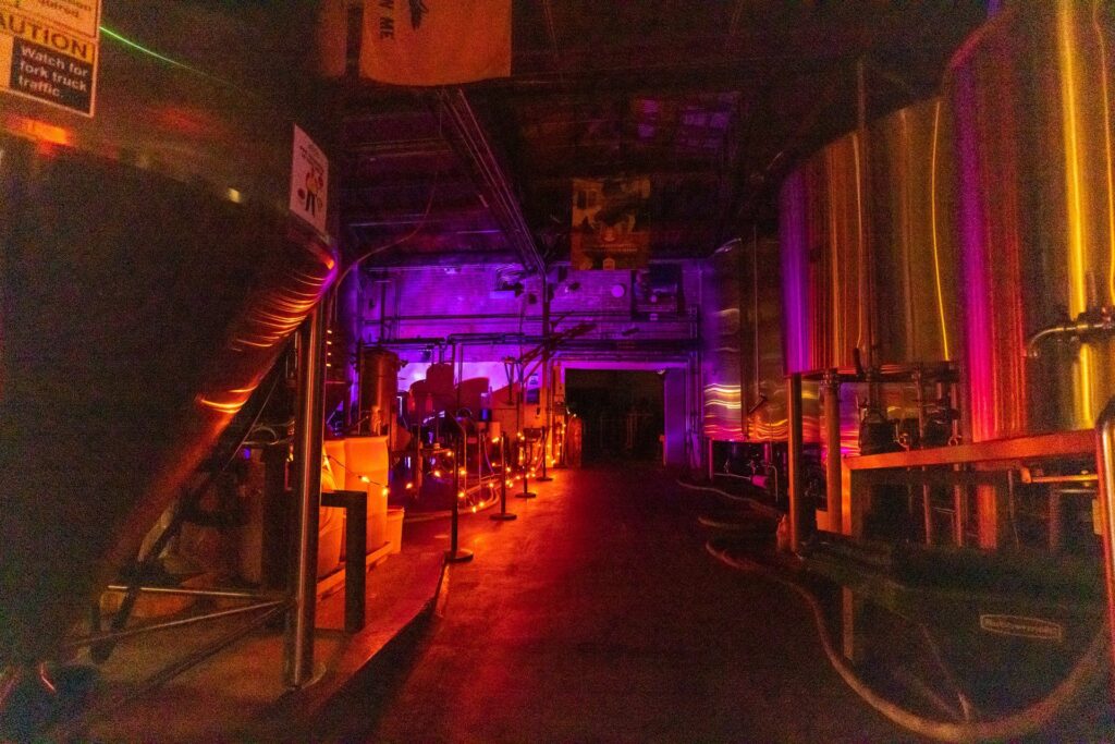 Four Peaks Brewery at night with orange lights along the side and purple lights