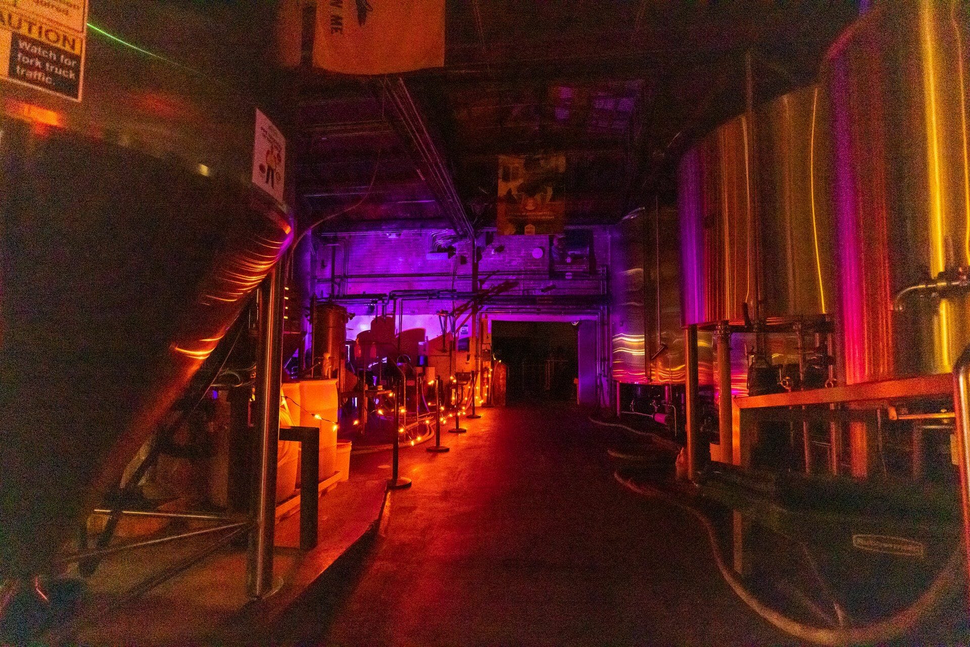 Four Peaks Brewery at night with orange lights along the side and purple lights