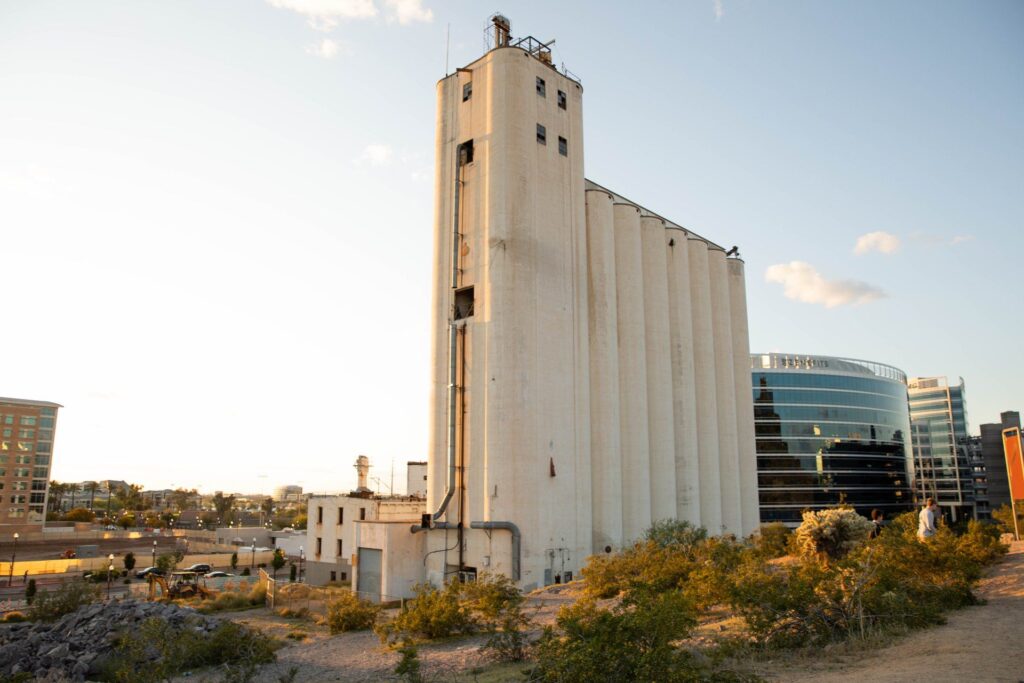 Side view of an old tall white flour mill