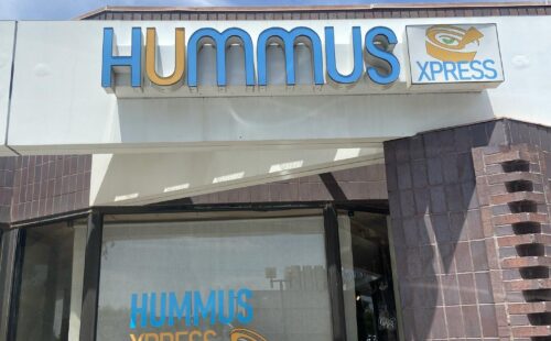 Front signage of a restaurant that says "Hummus Express"