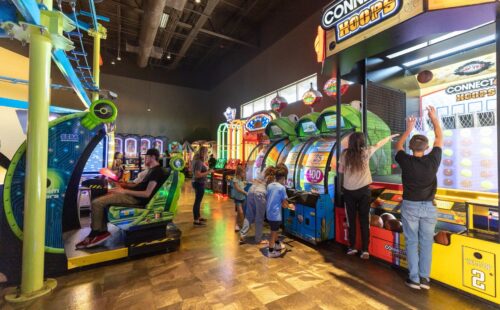 a variety of arcade games with people playing