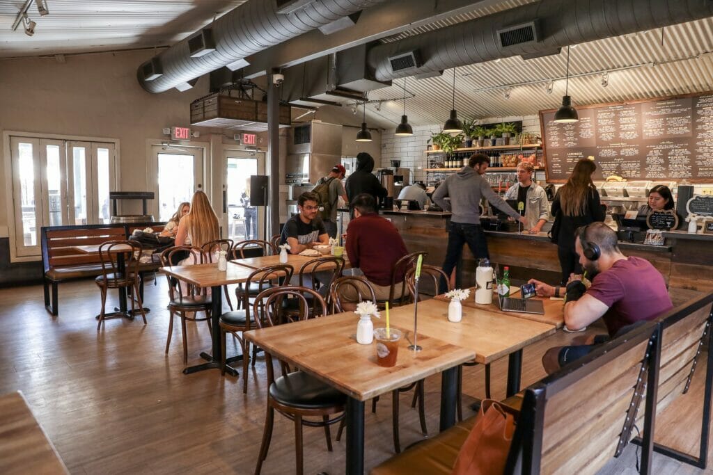 People eating and studying at tables inside ChopShop Tempe