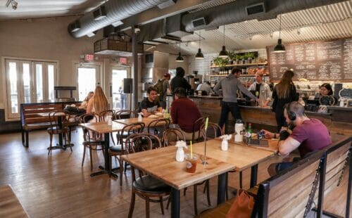 People eating and studying at tables inside ChopShop Tempe