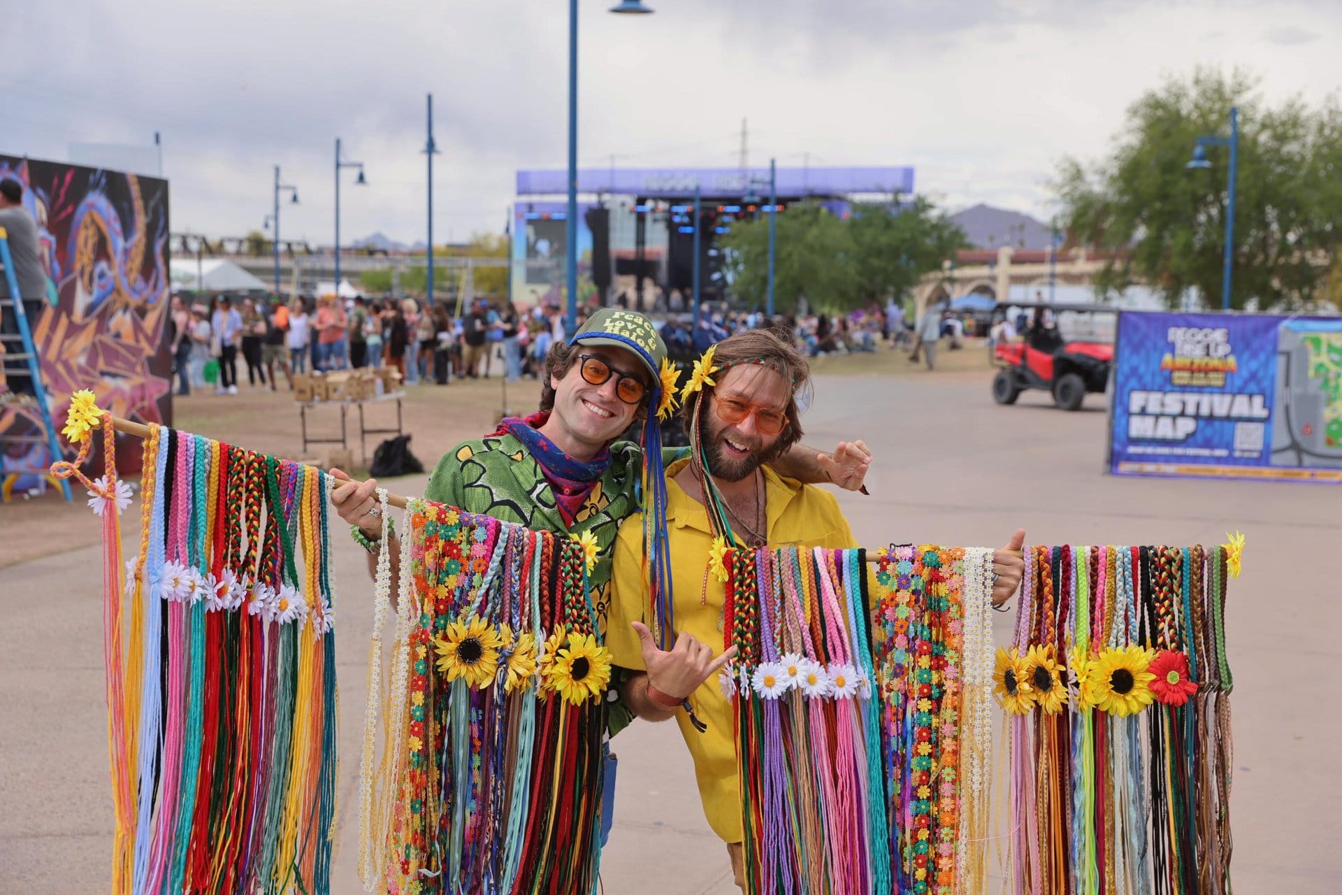 Festivalgoers dressed in bright colors display colorful beaded headbands.