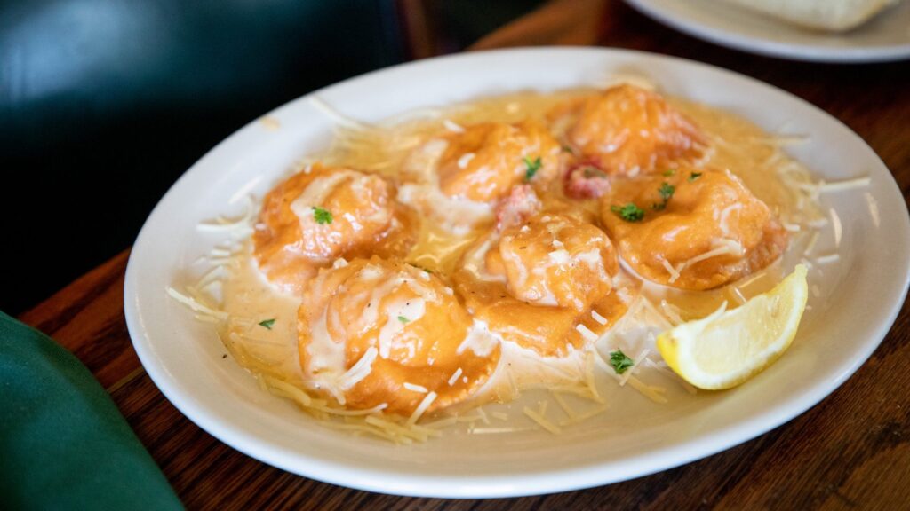 A plate of cheese ravioli with tomato cream sauce 