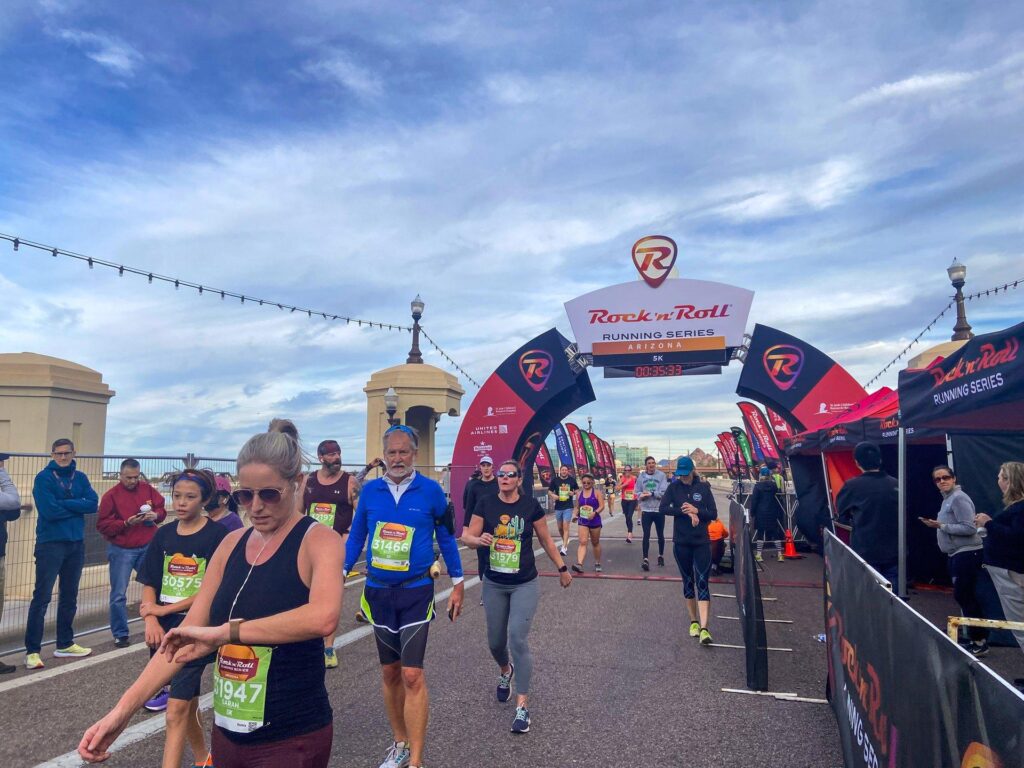 A group of runners cross the finish line