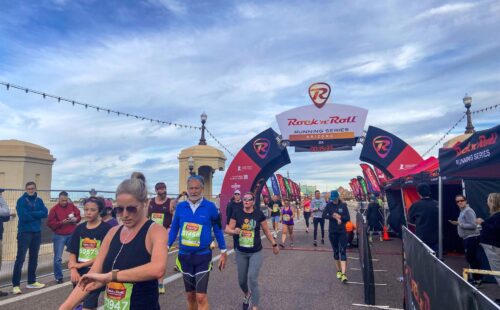 A group of runners cross the finish line