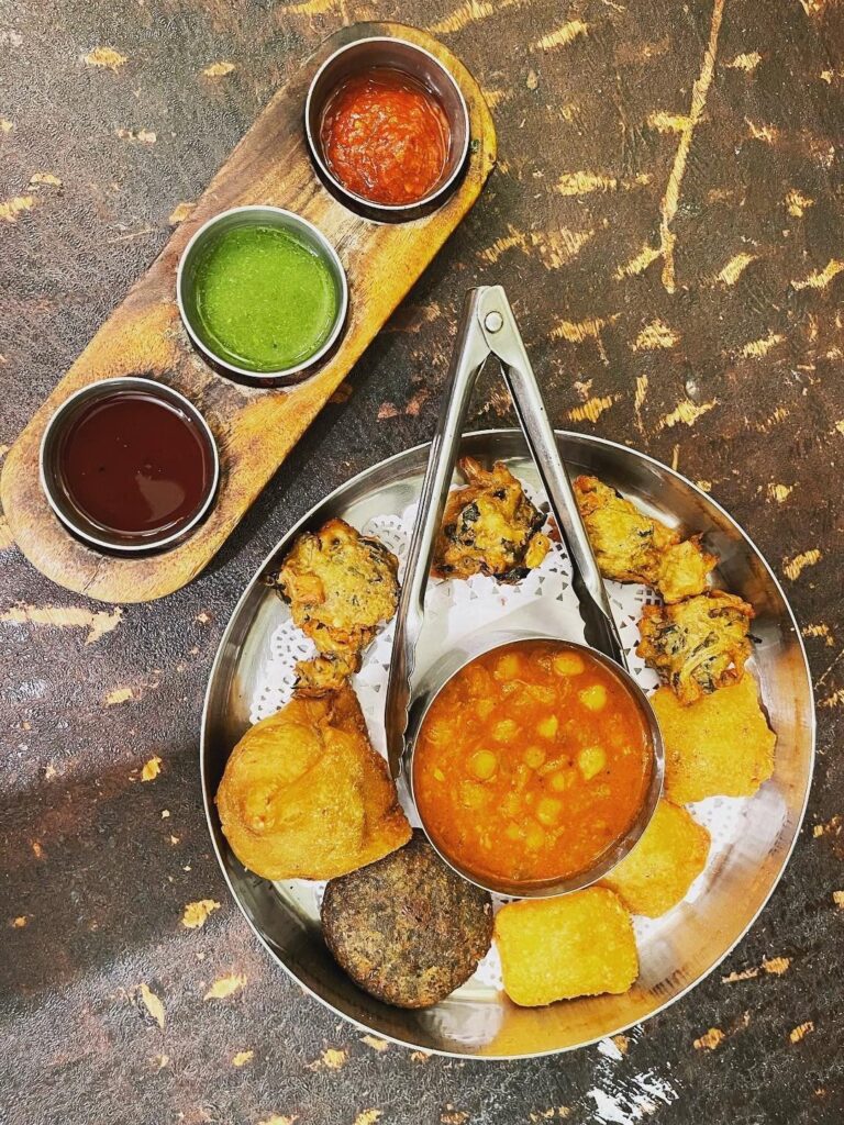 The Dhaba's Punjab veggie platter includes veggie and paneer pakoras, Samosa, tikki, Chole and chutneys.